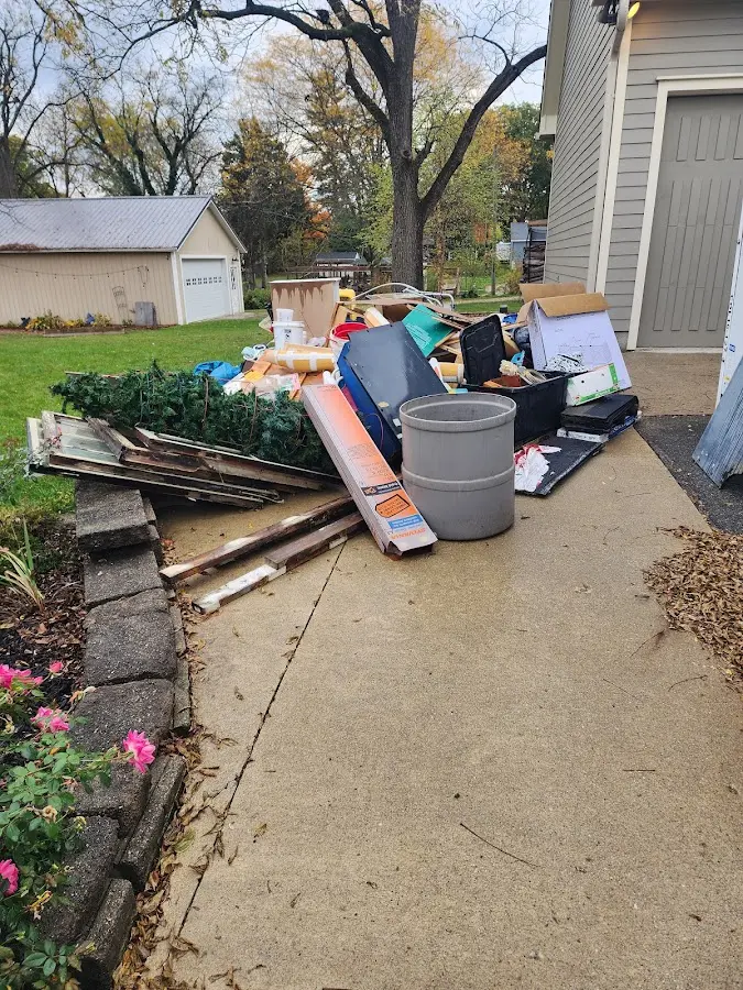 Dumpster being loaded with debris for 30 Yard Dumpster Rental in Wallace